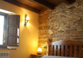 Double bedroom with stone wall