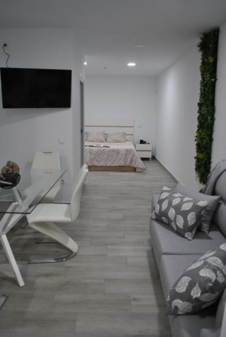 Salon-comedor con la cocina, todo en tonos azules, del apartamento 2
