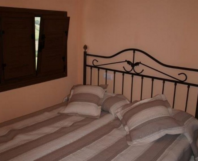 Dormitorio de matrimonio con colchas de rayas