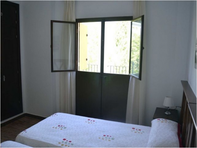 Dormitorio con camas individuales y terraza