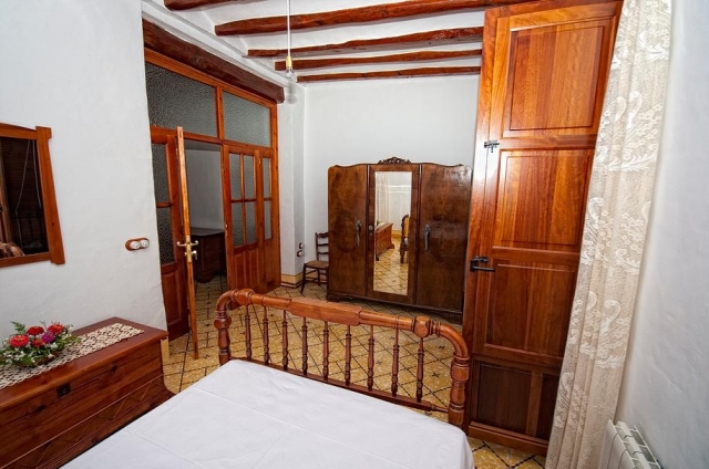 Dormitorio amarillo con cama doble y armario