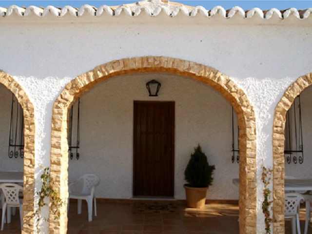  Entrance to the house, among trees 