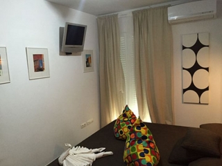 Dormitorio de matrimonio con televisor de plasma