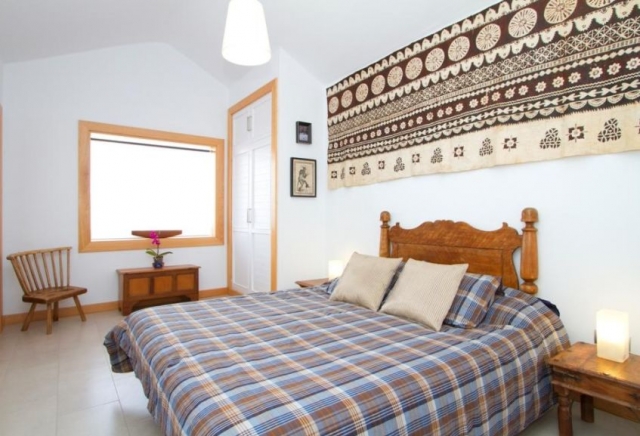 Dormitorio de matrimonio con colcha de cuadros