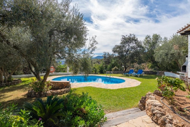 Amplia piscina con jardines