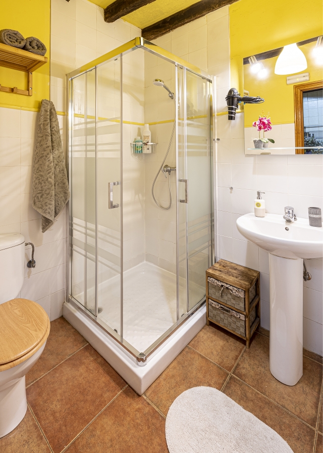 Un aseo con ducha amarilla
