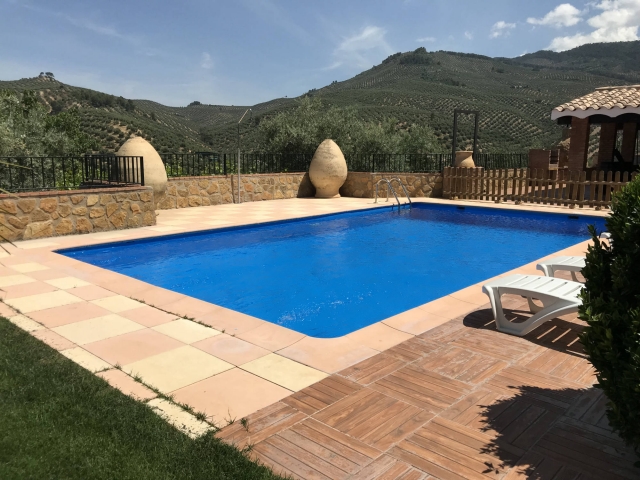 Amplio exterior de la casa con la piscina y las hamacas