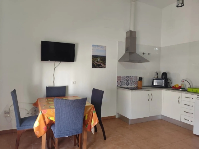 Cocina con mesa y tele