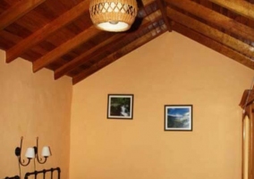 Dormitorio con dos camas individuales de rayas verdes y techos abuhardillados