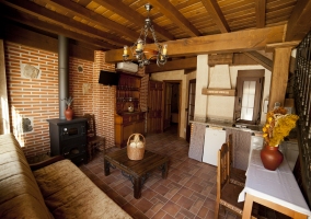 Cocina y salón unidos con mesa de comedor en la casa rural