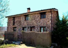 Fachada del alojamiento y entrada con valla