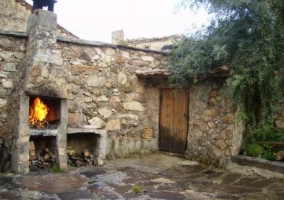 Sala de estar con paredes de piedra y sillones tapizados