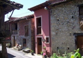 Acceso principal a la vivienda en piedra y con valla