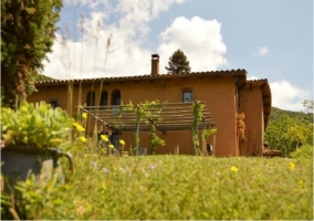 Fachada de la casa con porche y terrazas