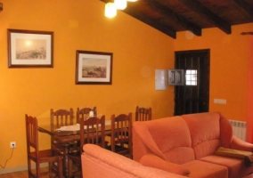 Sala de estar con sofás y el comedor al fondo