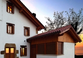 Fachada principal de la casa, con puertas y ventanas de madera