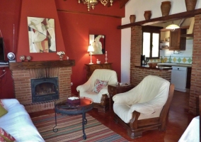 Sala de estar con mesa y chimenea en tonos rojos