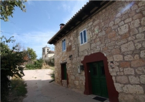 Acceso principal con fachada de piedra de la casa rural