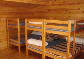 Dormitorio de una cabaña con mesa de madera