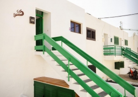 Acceso a la casa con escaleras en blanco y verde