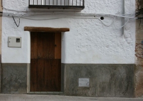 Entrada a la casa con puerta en madera