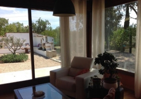 Sala de estar con suelos de madera y esa en cristal