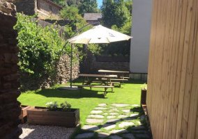 Acceso a la casa con fachada en piedra y detalles en madera