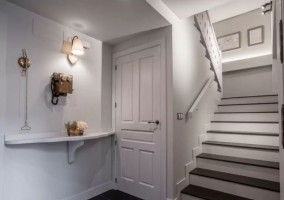 Entrada a la casa en blanco con escaleras y detalles