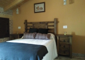 Bedroom with double bed and wooden headboard