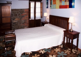 Dormitorio con cama de matrimonio y cuadros