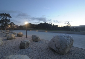 Cabañas y zona de jardín iluminados por la noche