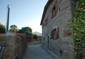 Detalles de los muros de piedra decorados con cuadros y mesa con bodegón