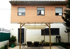 Terraza de la vivienda con mobiliario de jardín